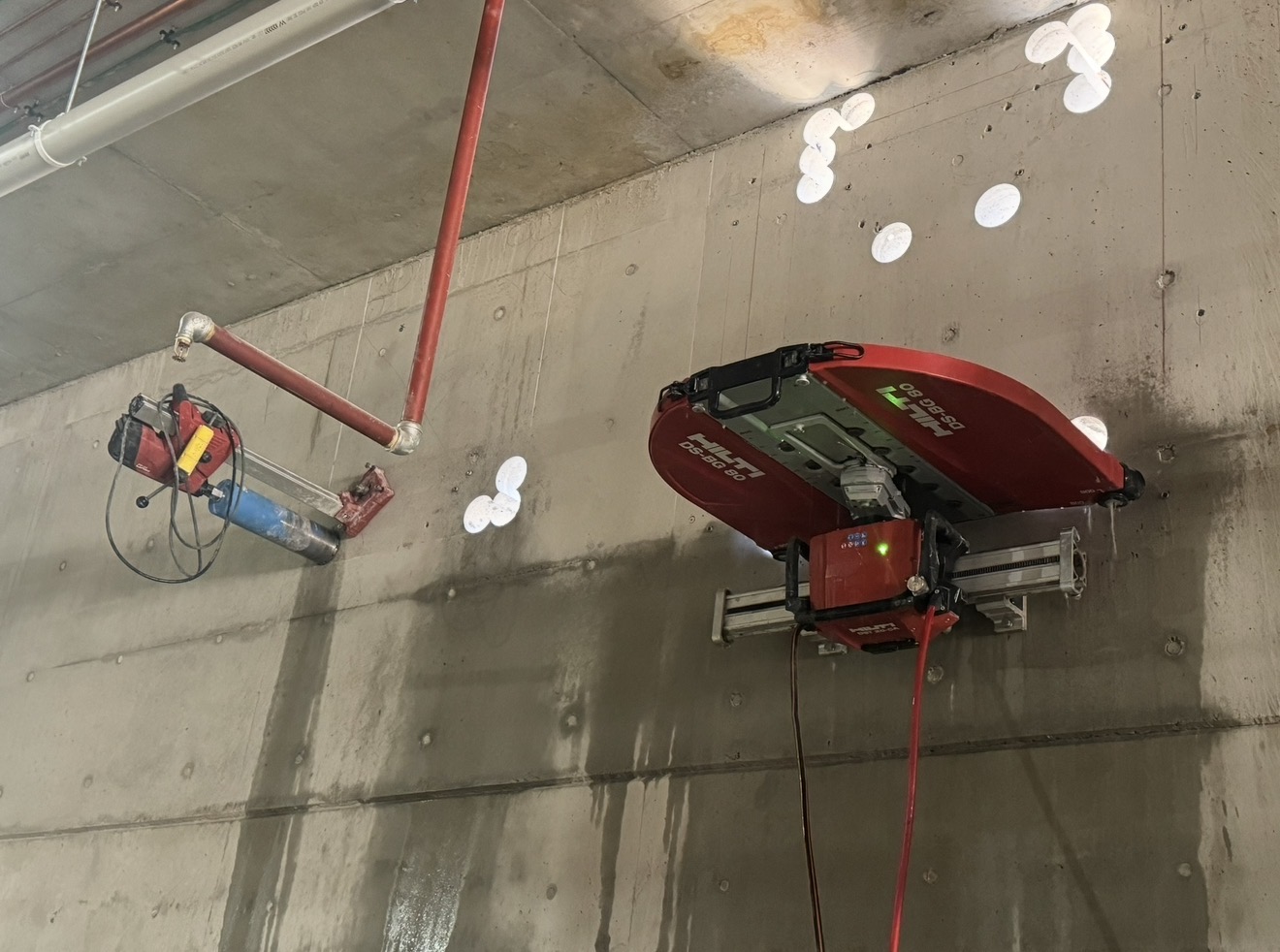 Track-mounted wall saw cutting a concrete wall on a Precision Cutting worksite